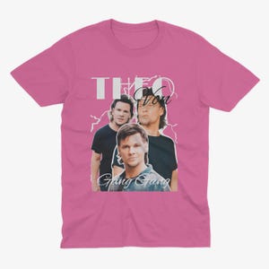May include: Pink t-shirt with a graphic of three men. The text "Theo Von Gang Gang" is printed on the shirt.