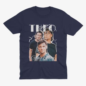 May include: Navy blue t-shirt with a white graphic of three men. The graphic includes the text "THEO" and "Gang Gang".
