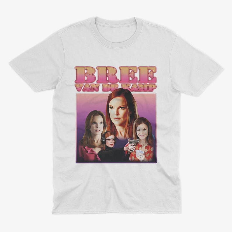 May include: White t-shirt with a pink and white graphic print of four women. The text "Bree Van De Kamp" is printed in pink and white.