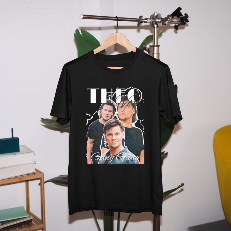 May include: Black t-shirt with a white graphic of three men with the text "Theo Gang Gang" printed on it.