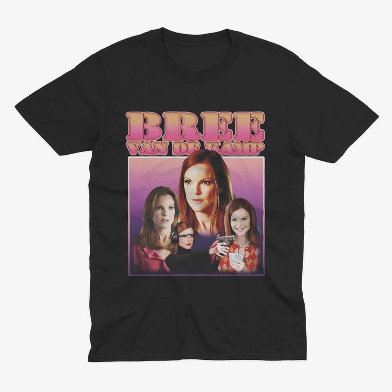 May include: Black t-shirt with a pink and white graphic of Bree Van de Kamp from the TV show Desperate Housewives. The graphic features Bree, her daughter Danielle, and her friend, Katherine Mayfair.