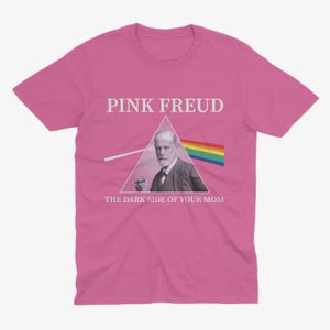 May include: Pink t-shirt with a graphic of Sigmund Freud in a triangle with a rainbow prism and the text "Pink Freud The Dark Side of Your Mom".