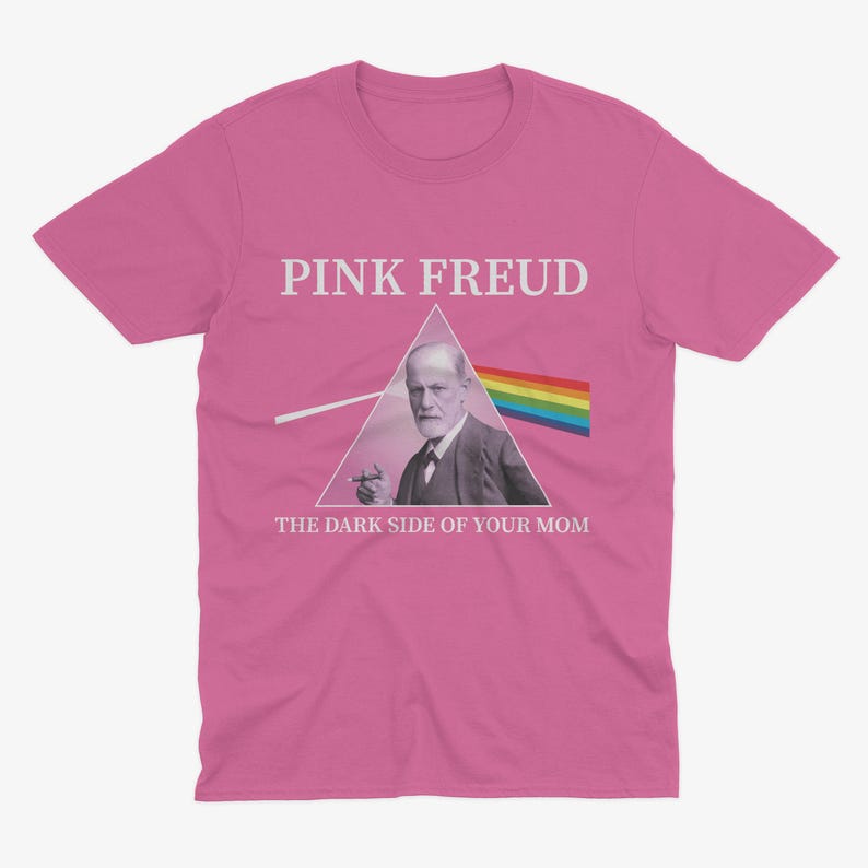 May include: Pink t-shirt with a graphic of Sigmund Freud in a triangle with a rainbow prism and the text "Pink Freud The Dark Side of Your Mom".