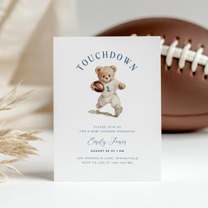 May include: A baby shower invitation with a watercolor illustration of a teddy bear holding a football. The invitation text reads "TOUCHDOWN" and includes details for the event, such as the honoree's name, date, time, and location.