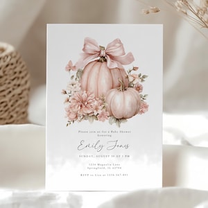 May include: Baby shower invitation featuring a watercolor design with two pumpkins, a large bow, and floral accents in soft pink and peach tones. The invitation includes the text "Please join us for a Baby Shower honoring Emily Jones."