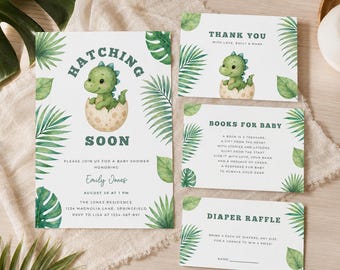 May include: A set of baby shower stationery featuring a green dinosaur hatching from an egg, decorated with watercolour tropical leaves. The cards include text for an invitation, a thank you note, a book request, and a diaper raffle entry.