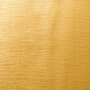 May include: Close-up of a textured, golden-yellow surface. The surface has a horizontal, brushed appearance, with subtle variations in tone and texture. The overall effect is a warm, metallic sheen.
