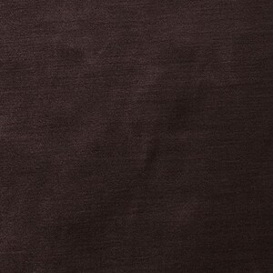 May include: A close-up of a dark brown fabric with a subtle texture. The fabric has a smooth, even surface with a slight sheen.