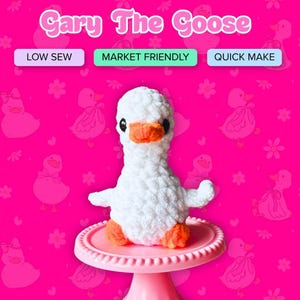 May include: A white plush goose toy with an orange beak and orange feet, featuring black eyes. The text Gary The Goose, LOW SEW, MARKET FRIENDLY, and QUICK MAKE appears above the toy against a bright pink background with a repeating duck pattern.