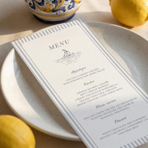 May include: A rectangular menu card with a white background and grey striped borders. The text reads MENU with a sailboat illustration, followed by sections for Appetizer, Starter, Main course, and Dessert, listing various food items in black font.