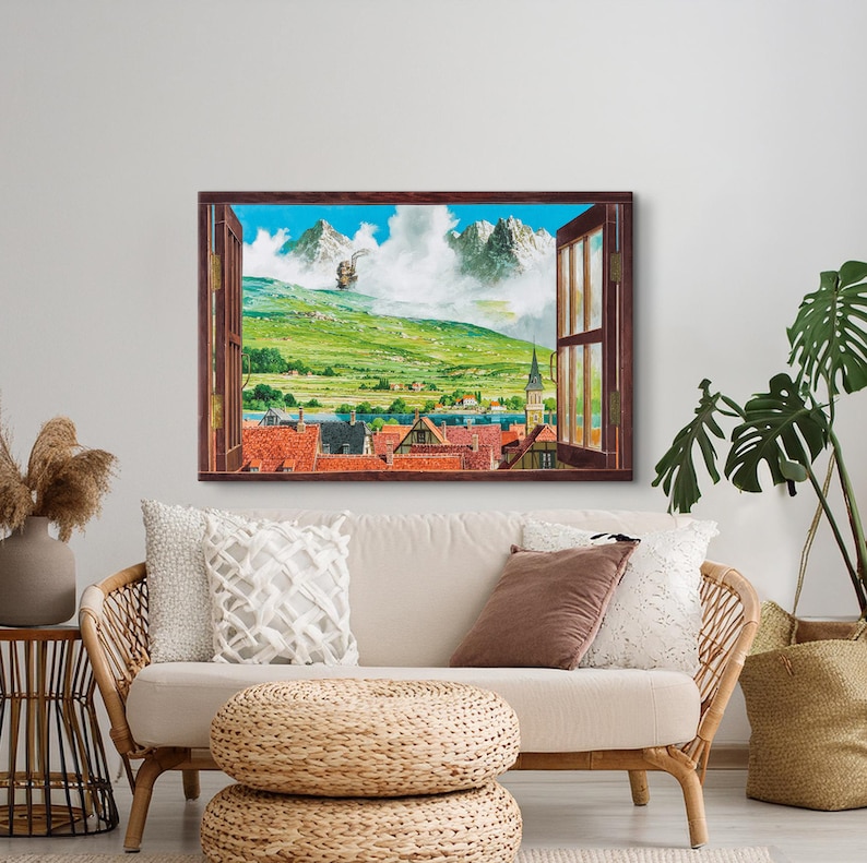 May include: A painting of a window view with a small town in the distance. The town is nestled in a valley with mountains in the background. The sky is blue with white clouds. The window is open and the curtains are drawn back. The painting is framed in a brown frame.