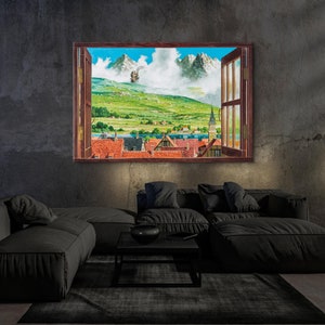 May include: A painting of a window with a view of a small town nestled in a valley with mountains in the background. The window is open and the view is framed by a wooden frame.