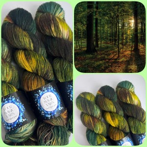 Könnte beinhalten: Handgefärbte Garnstränge in Grün-, Gelb- und Brauntönen. Das Garn ist ansprechend präsentiert, mit Etiketten mit der Aufschrift "YOUR MAGIC YARN hand dyed yarn". Eine Waldszene ist ebenfalls enthalten.