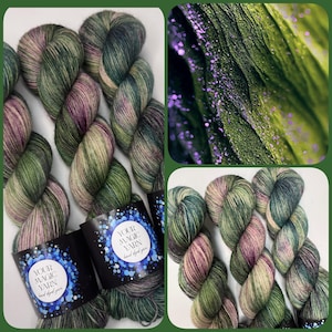 May include: Hand-dyed yarn skeins in shades of green, pink, and cream. The yarn is arranged in a collage with a close-up of green fabric with purple glitter and labels that read "YOUR MAGIC YARN hand dyed yarn".