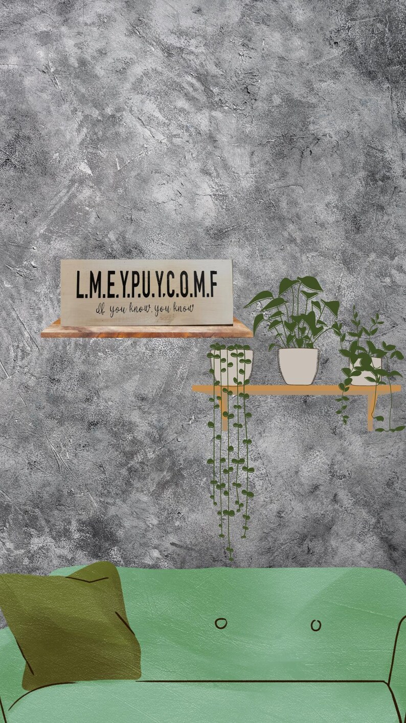 May include: A green couch with a green pillow in front of a gray wall. A wooden shelf with three potted plants is mounted on the wall. The shelf has a sign that reads "L.M.E.Y.P.U.Y.C.O.M.F. If you know, you know."
