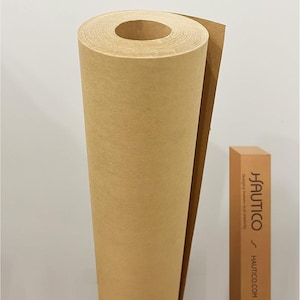 May include: A large roll of kraft paper, ideal for art projects or packaging. The paper is a warm brown color and is tightly rolled. A rectangular box with the text "HAUTICO" is visible.