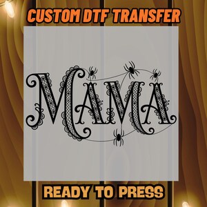 May include: A gray rectangular DTF transfer with the word "MAMA" in a decorative black font, adorned with spiders. The text "CUSTOM DTF TRANSFER" and "READY TO PRESS" are in orange and black.
