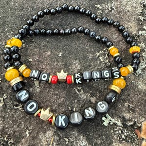 May include: A rustic wooden sign with the text "Welcome to our home" in white lettering. The sign features a distressed finish and a simple, inviting design, perfect for entryway decor.