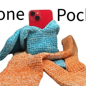 May include: A red smartphone is held in a blue crocheted pocket, with orange crocheted gloves. The text "Phone Pocket" is displayed above the phone. The image is set against a white background.