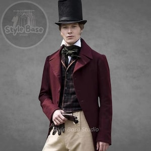 May include: A man wearing a burgundy frock coat with a black top hat, a white collared shirt, a black bow tie, a plaid vest, and beige pants.