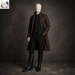 May include: A brown overcoat, black vest, and black pants ensemble. The outfit includes a white collared shirt and black knee-high boots. The coat is long and buttoned, and the vest has silver buttons. The mannequin is standing in front of a dark background.