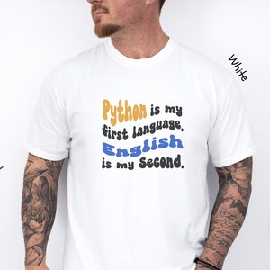 May include: White t-shirt with a graphic that says "Python is my first language, English is my second."