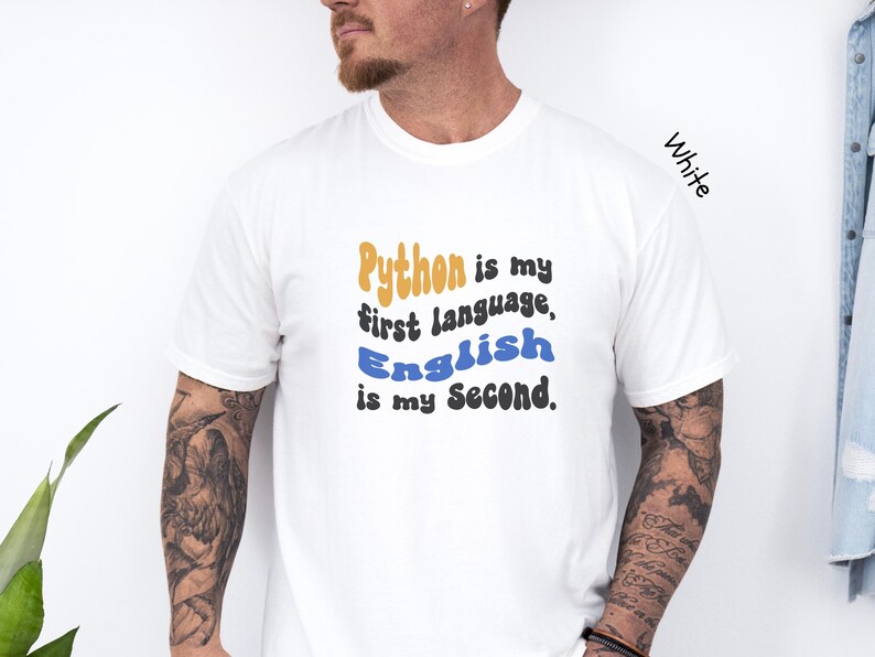 May include: White t-shirt with a graphic that says "Python is my first language, English is my second."