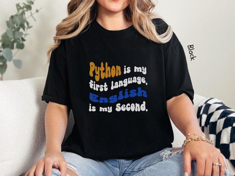 May include: Black t-shirt with the text "Python is my first language, English is my second."