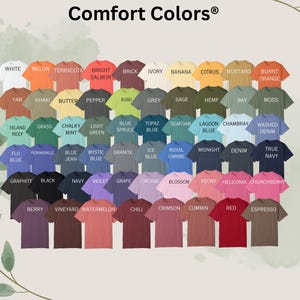 May include: A chart of 50 different colored t-shirts with the brand name "Comfort Colors" at the top. The colors are arranged in rows and columns, with each color labeled with a name.