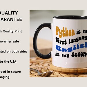 May include: White ceramic coffee mug with a black handle and black rim. The mug has a graphic that says "Python is my first language, English is my second."