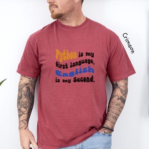 May include: A crimson t-shirt with the text "Python is my first language, English is my second."