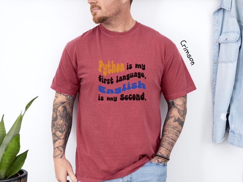 May include: A crimson t-shirt with the text "Python is my first language, English is my second."