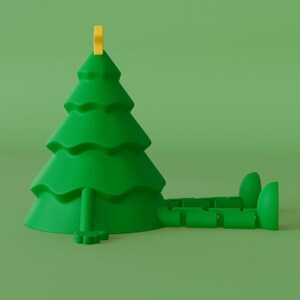 Puede incluir: Figura de &aacute;rbol de Navidad verde con una estrella amarilla. El &aacute;rbol tiene un dise&ntilde;o caprichoso con un cuerpo y pies segmentados, sobre un fondo verde. Un art&iacute;culo decorativo y divertido.