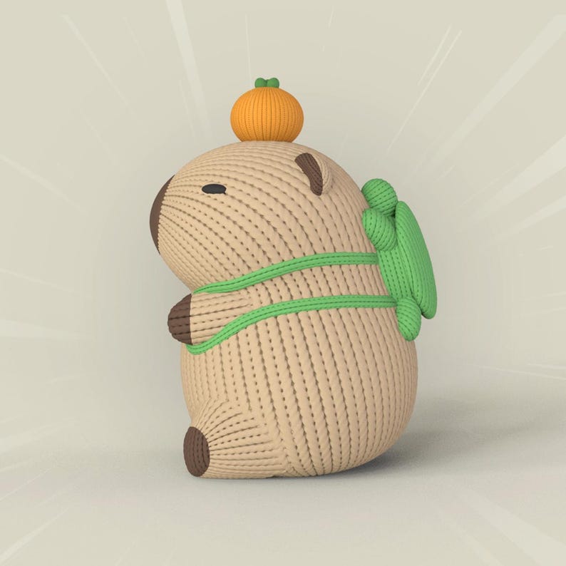 May include: A brown knitted capybara plush toy with a green backpack and an orange pumpkin on its head.