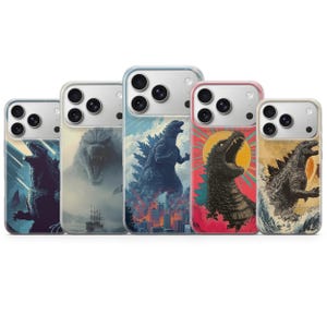 May include: Five phone cases with Godzilla-themed artwork. Each case features a different design, including Godzilla roaring, set against various backgrounds like cityscapes, ocean waves, and a rising sun. The cases have clear edges and a glossy finish.