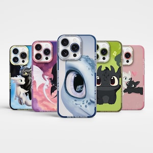 Può includere: Cinque custodie per telefono con illustrazioni di draghi. Le custodie presentano diversi personaggi di draghi in nero, bianco, blu e rosa. Il testo "ANIME DRAGON" e "HOW TO TRAIN DRAGON" è visibile. Le custodie sono per un telefono cellulare.