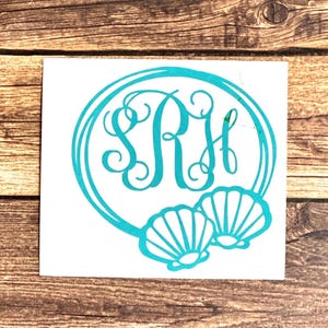 May include: Teal blue monogram decal with the letters "SRH" in a circle with two teal blue seashells below the circle.