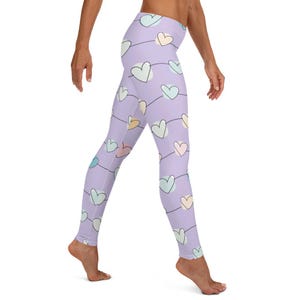 May include: Purple leggings with a pattern of colorful hearts connected by a string. The hearts are in various shades of pink, blue, green, and yellow.