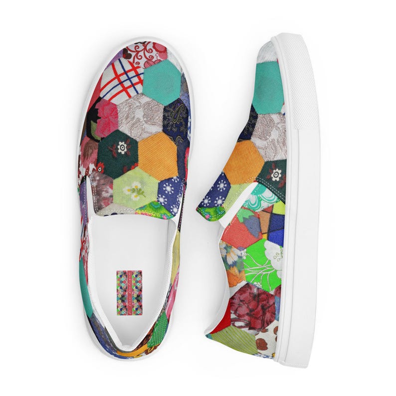 May include: A pair of white slip-on canvas shoes with a colorful patchwork design. The design features a variety of fabrics and patterns, including floral, geometric, and plaid.