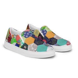 May include: A pair of white canvas slip-on shoes with a colorful patchwork design. The design features a variety of fabrics in different colors and patterns, including floral, paisley, and geometric prints.
