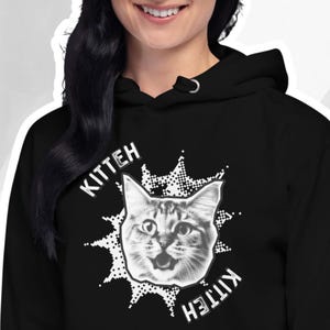May include: Black hoodie with a white graphic of a cat with the word "Kitten" on either side of the cat.