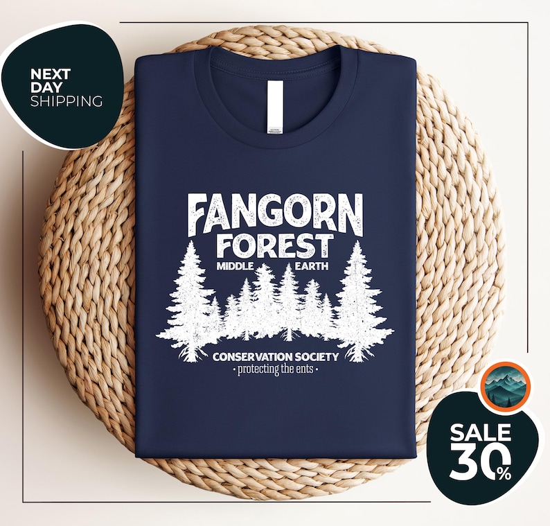 a blue t - shirt with a forest scene on it