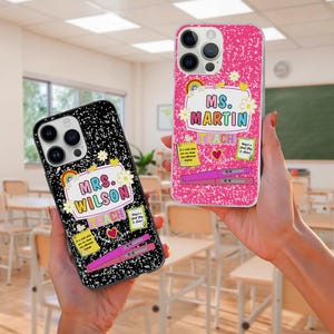 May include: Two phone cases with teacher-themed designs. One case is black with white speckles and the text "MRS. WILSON TEACH". The other is pink with the text "MS. MARTIN TEACH". Both cases have rainbow and flower accents.