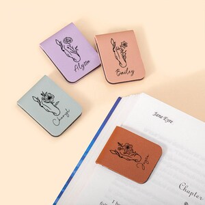 May include: Four personalized leather bookmarks with a floral design and names "Alyssa", "Bailey", "Cheryl", and "Joyee".