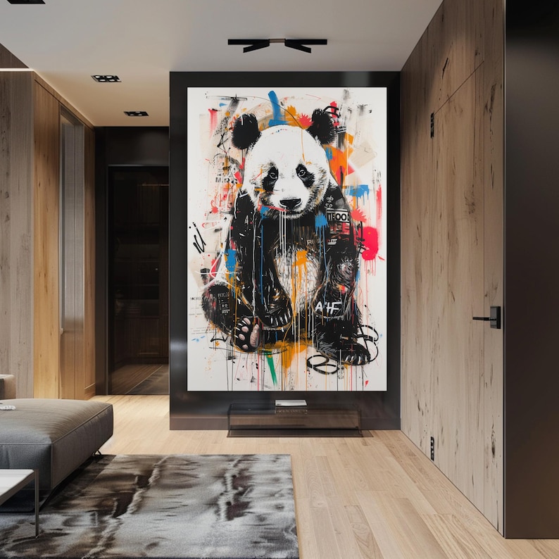 May include: A black and white panda bear with colourful abstract paint splatters in the background. The panda is wearing a black and white bandana with the word "TOOL" written on it. The panda is sitting on its haunches with its paws in front of it. The panda is looking at the viewer.