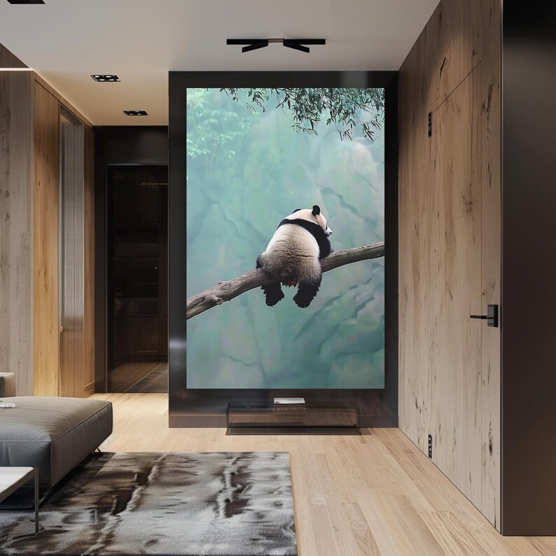May include: A black and white panda bear sits on a branch with a blurred green and blue background.