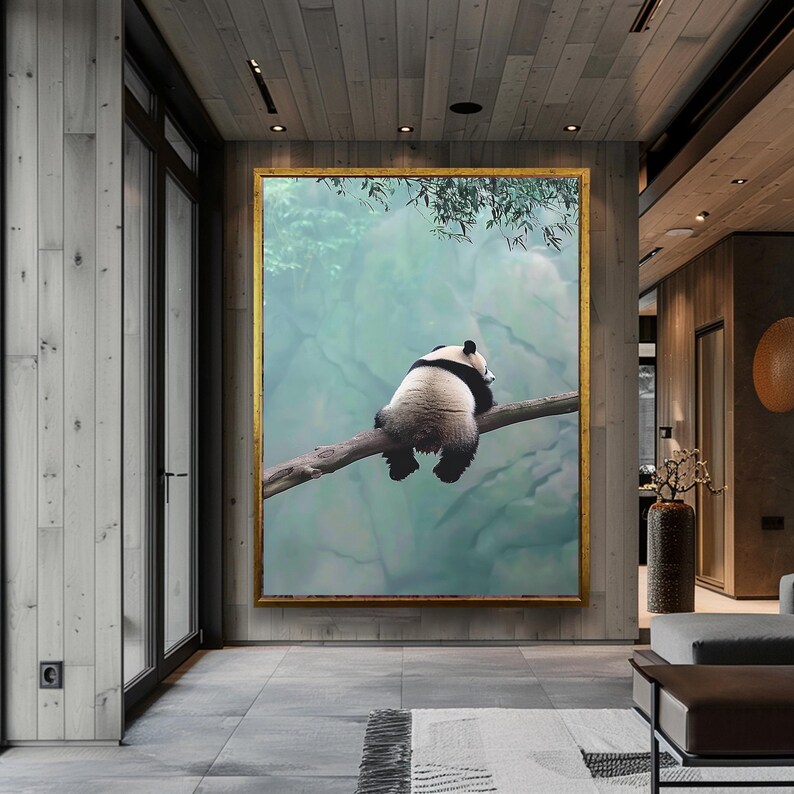 May include: A black and white panda bear sits on a branch in a forest setting. The panda is looking off to the side, with its back to the viewer. The background is a soft, green and blue watercolor wash.
