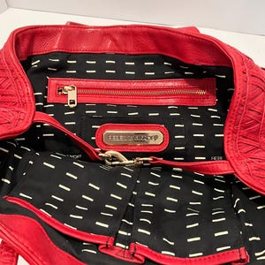 May include: A white ceramic mug with a black handle and the text "But First, Coffee" in a black, bold font. The mug is sitting on a white surface.