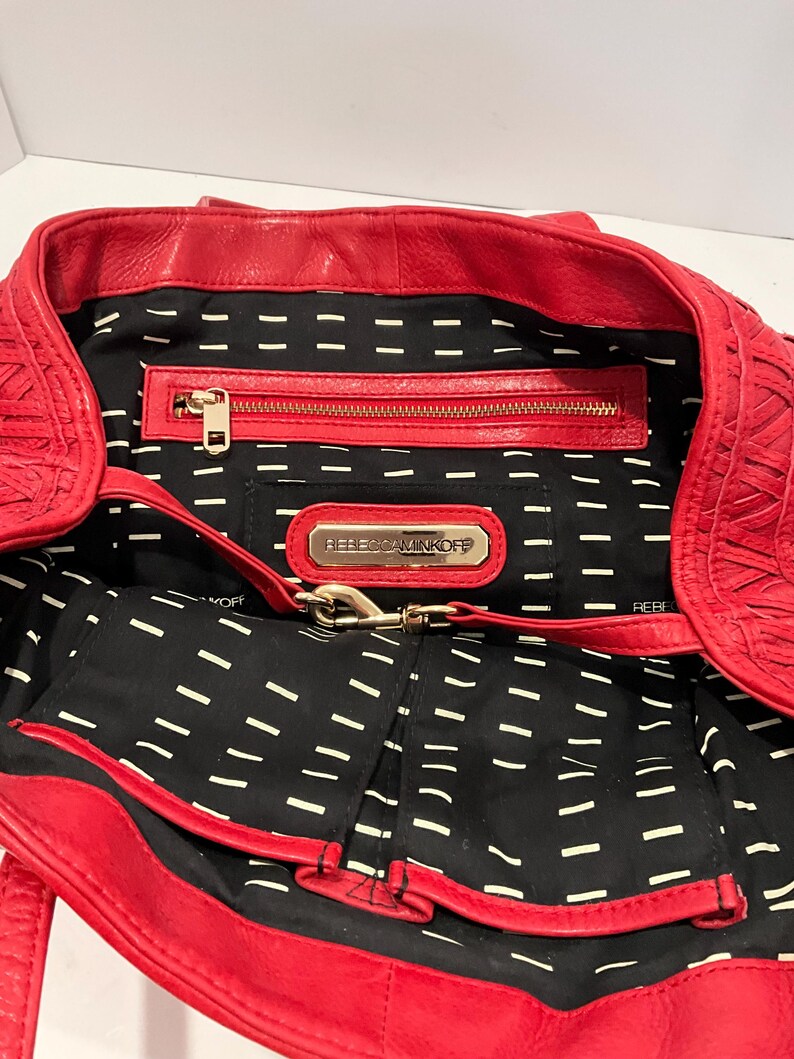 May include: A white ceramic mug with a black handle and the text "But First, Coffee" in a black, bold font. The mug is sitting on a white surface.