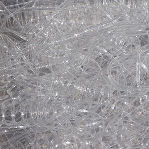 May include: A pile of clear plastic hangers, tangled together. The hangers are made of thin, flexible plastic and are designed to hold clothes.